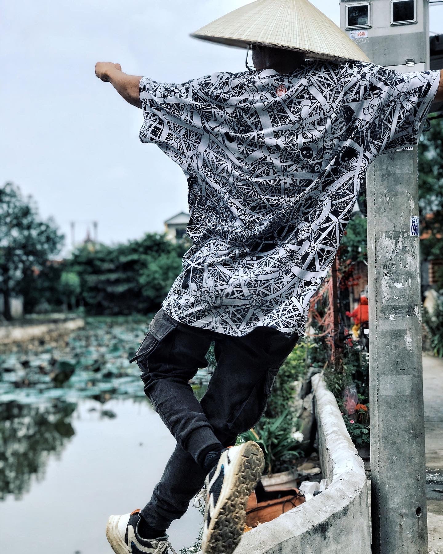 asian hat wearing black and white all over printed tshirt by heiner radau