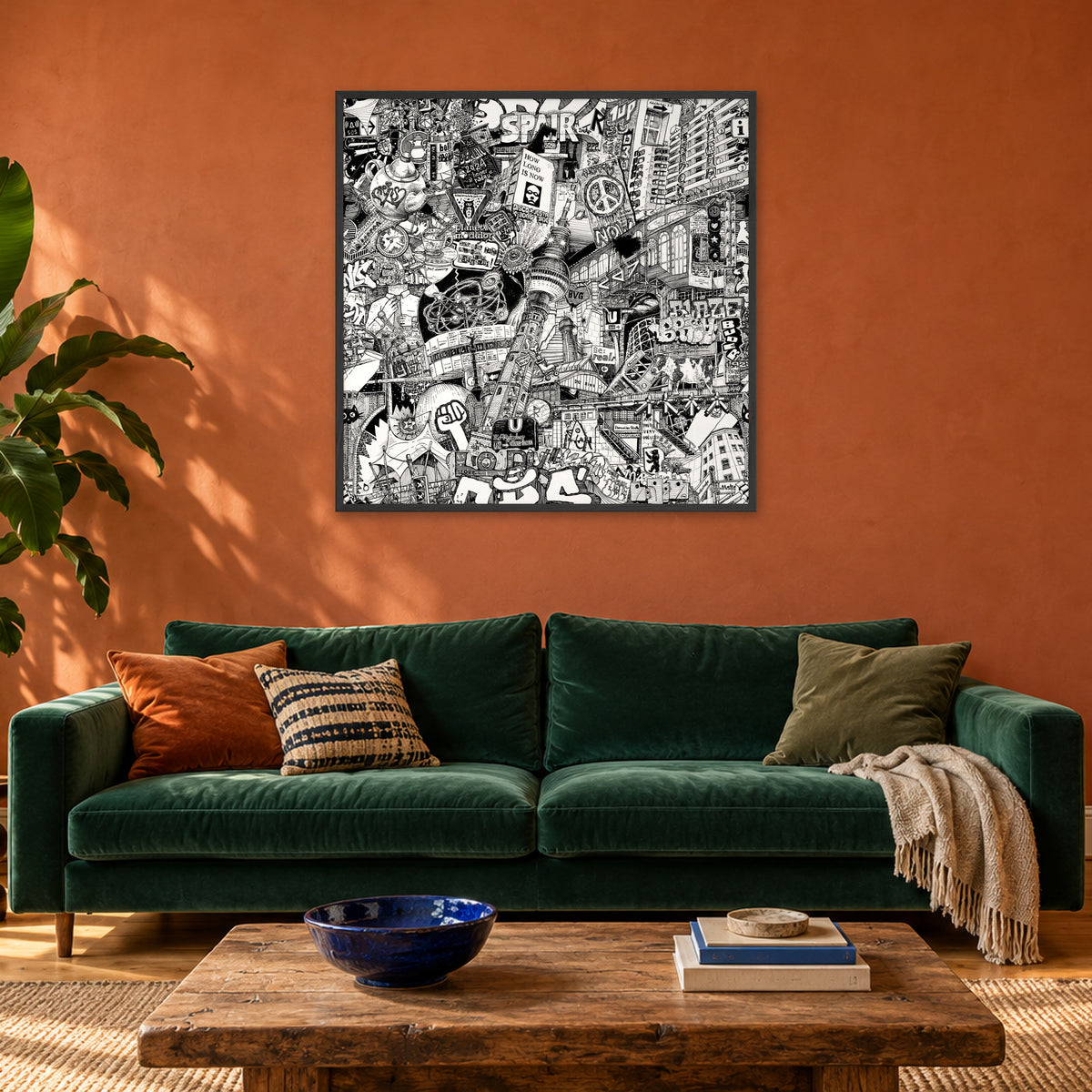 Berlin fine art poster 100 × 100 cm in a black wood frame above a green velvet sofa in a terracotta living room