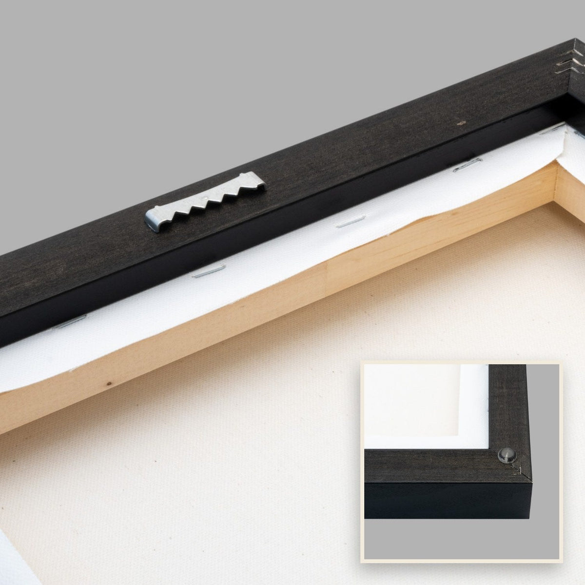Back of the framed canvas with pre-mounted metal sawtooth hanger and rubber spacer.