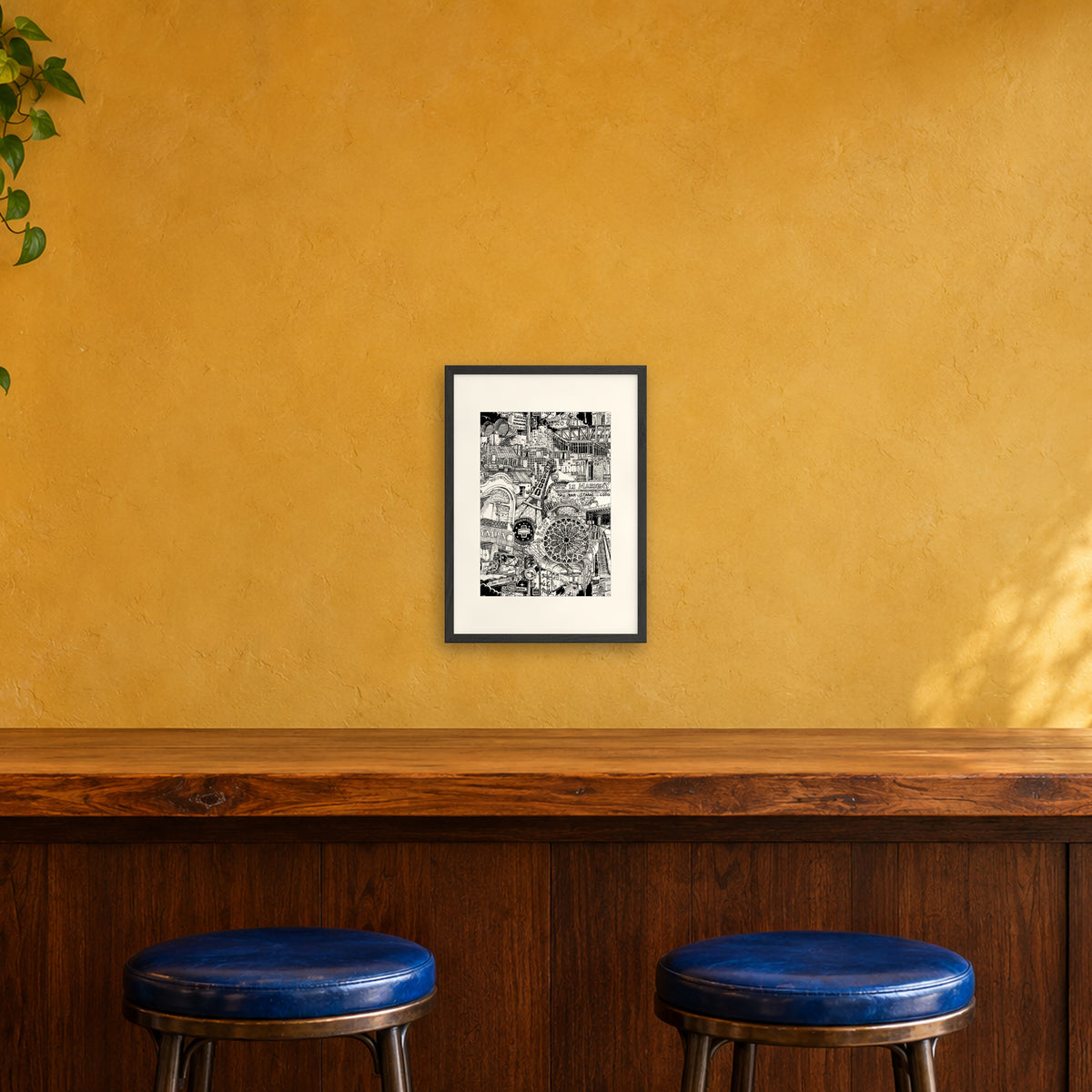Paris fine art poster A3 portrait in a black wood frame with white passepartout above a café bar counter