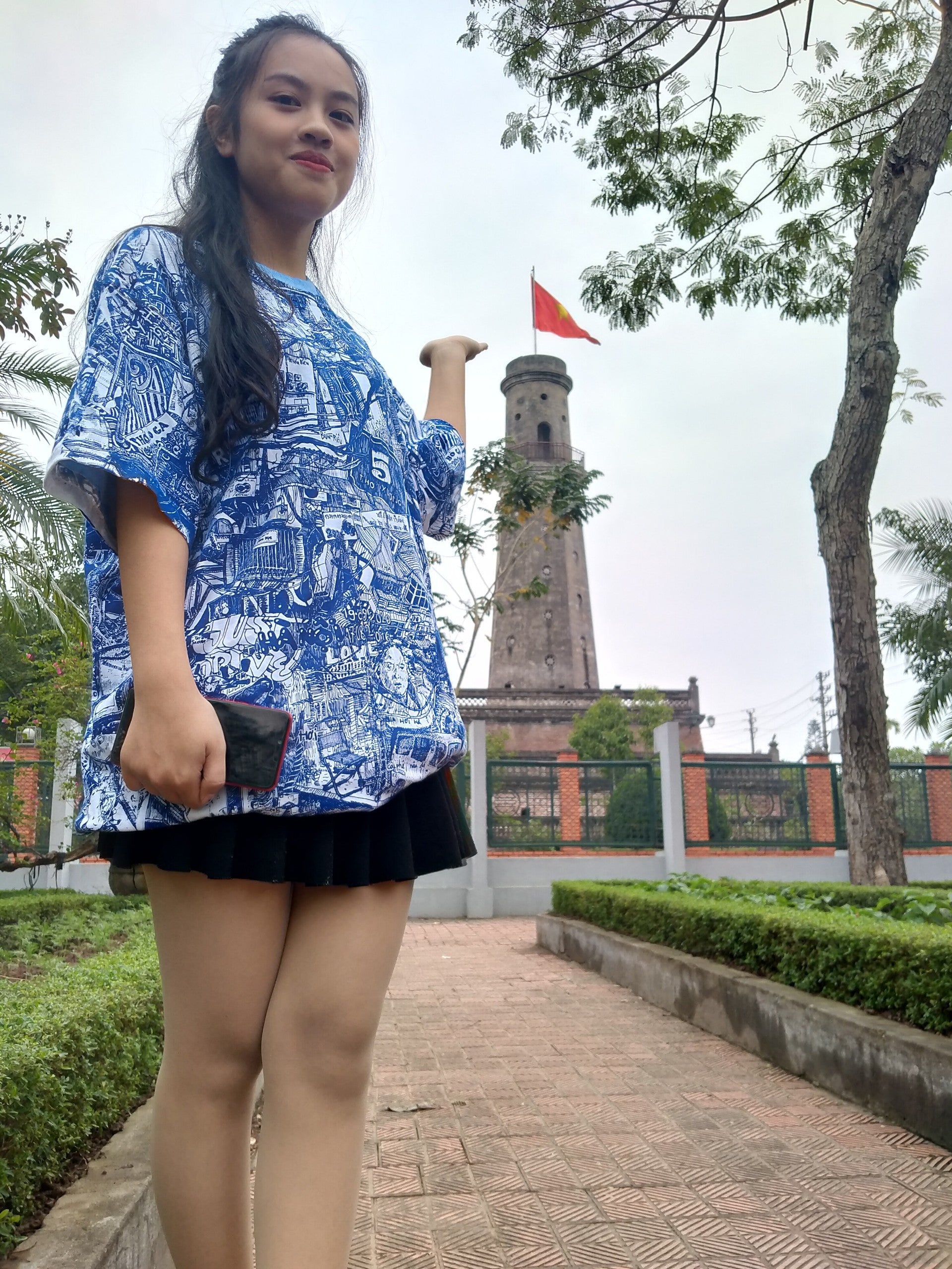 vietnamese pretty young woman wearing blue and white all over printed HANOI city tshirt by heiner radau
