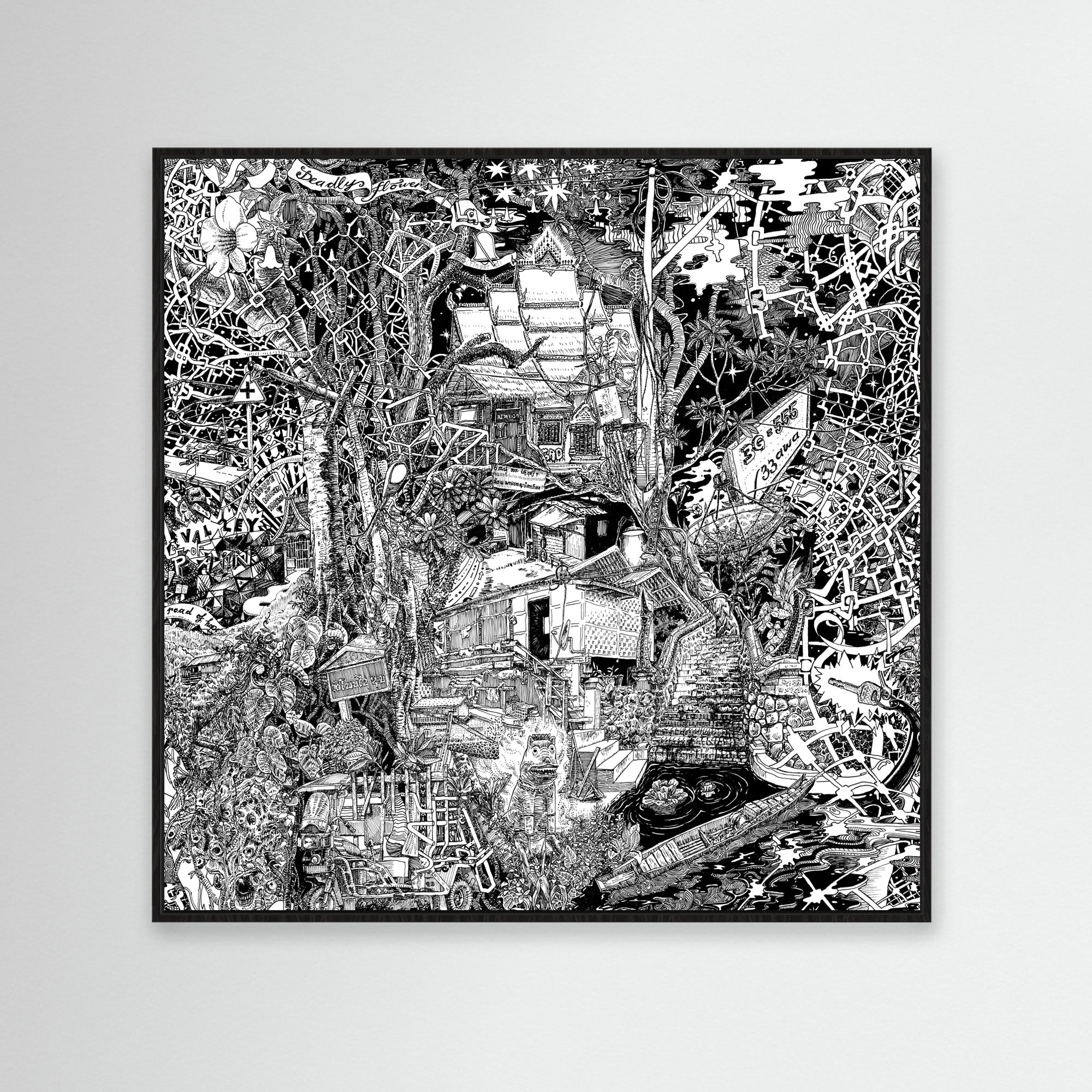 Framed black-and-white cityscape of Luang Prabang in a black frame, with forest details, three-wheeled tuk-tuks, and Laotian street art.