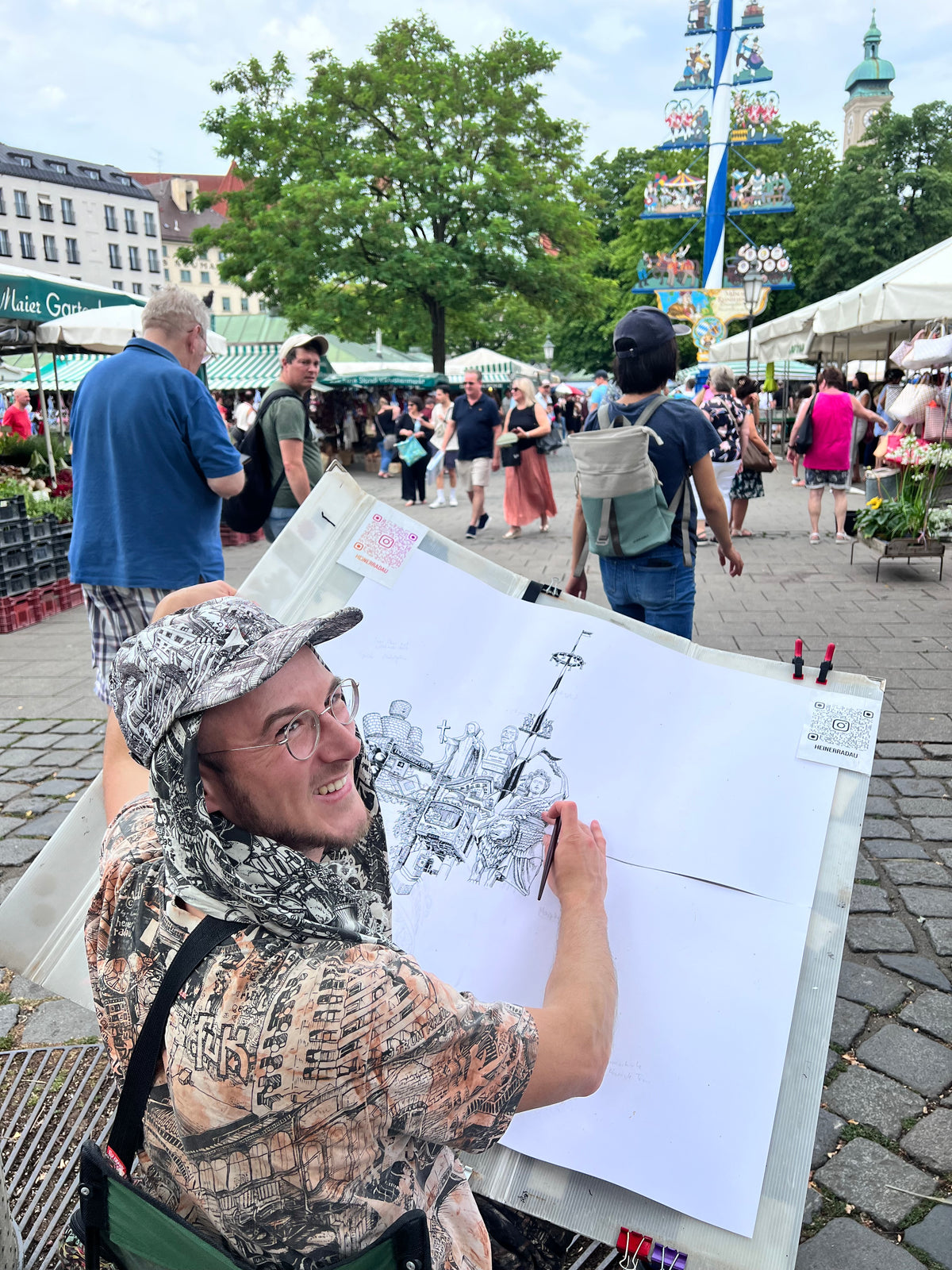 Heiner Radau zeichnet den Maibaum auf dem Viktualienmarkt — das Muenchen-Kunstwerk entsteht live im Herzen der Stadt.