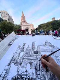 Artist POV urban sketching at Washington Square Park in New York, with drawing materials, park life and the arch in view.