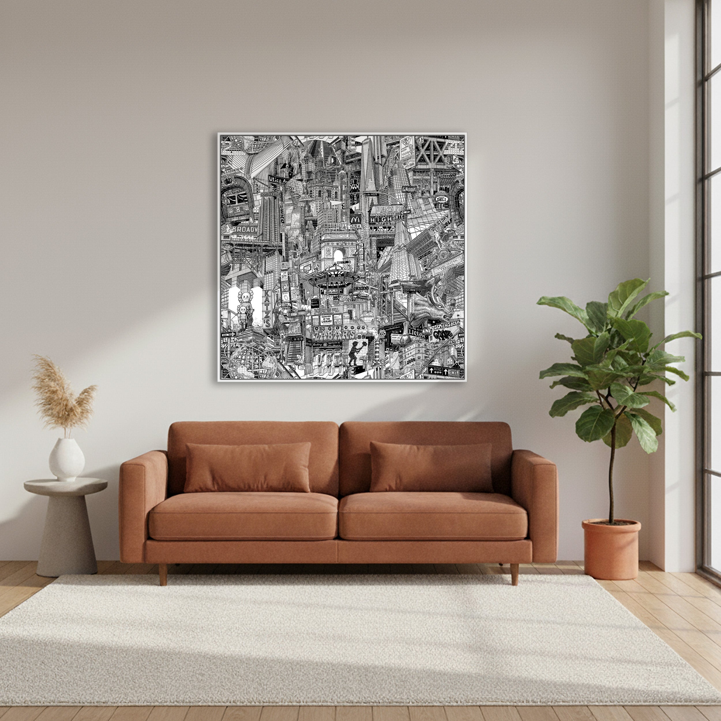 Living room with a brown sofa, city art on the wall, and a plant.