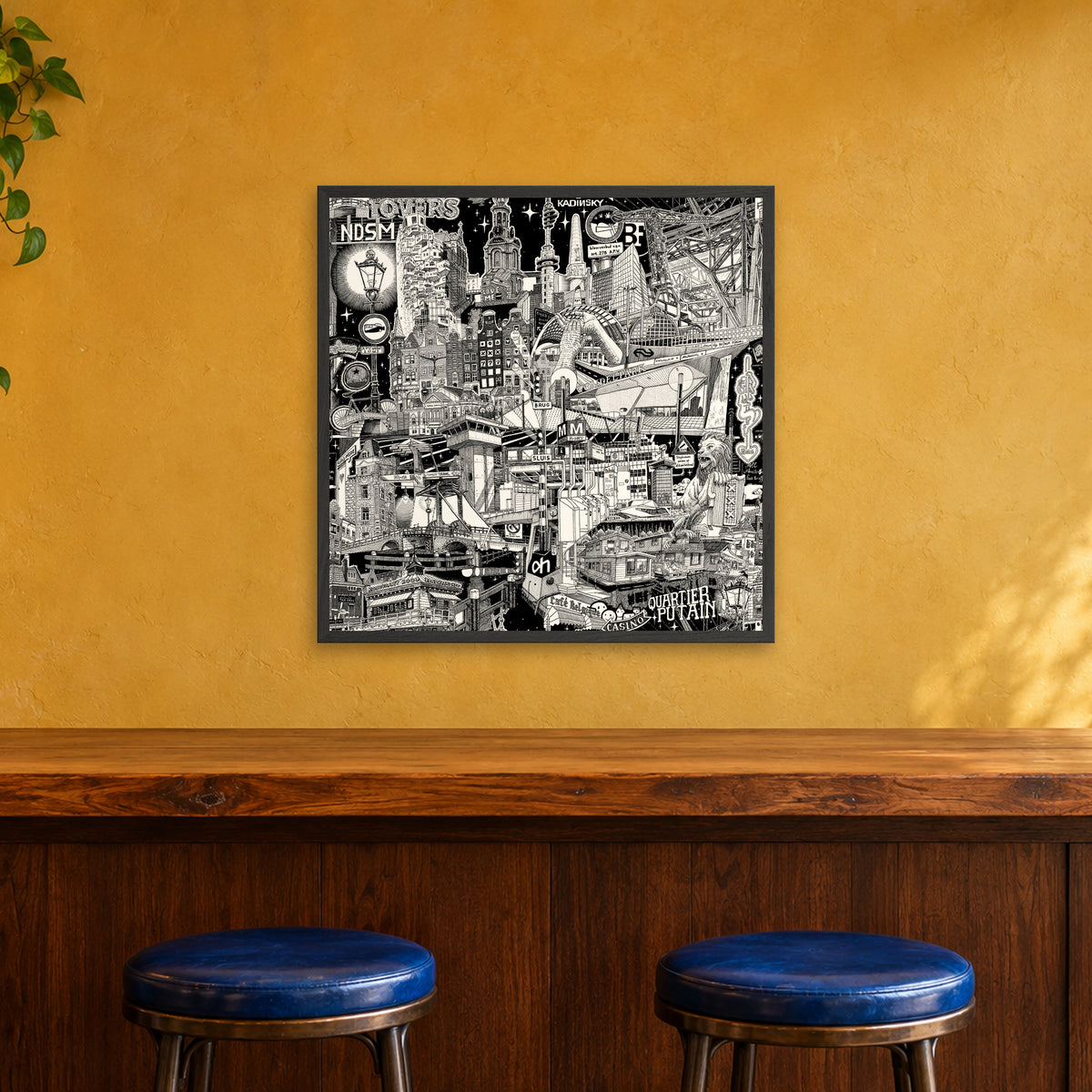 Amsterdam fine art poster 70 × 70 cm in a black wood frame above the counter of a café bar