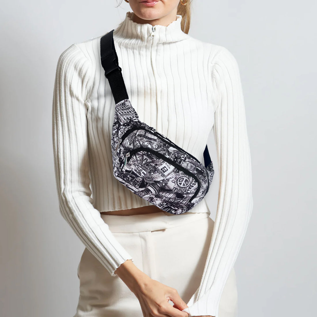 Model wearing black and white Berlin print bumbag crossbody over a white ribbed sweater