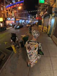 New York Chinatown night street scene with neon signs and drawing materials, part of the NYC artwork process.