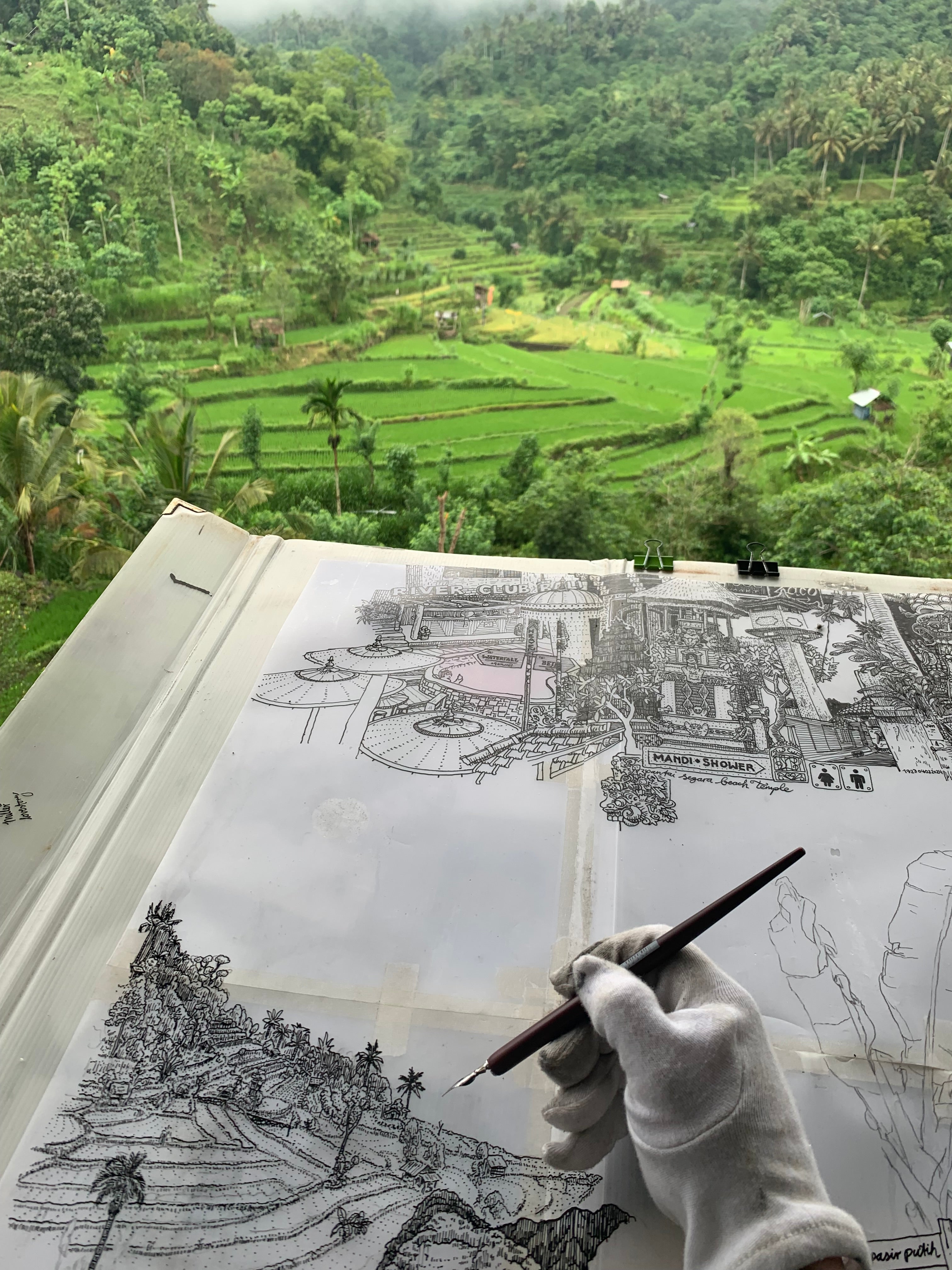 artist drawing rice fields and mountains in Bali, using ink and fountain pen, handdrawn bali black and white, bali artwork souvenir