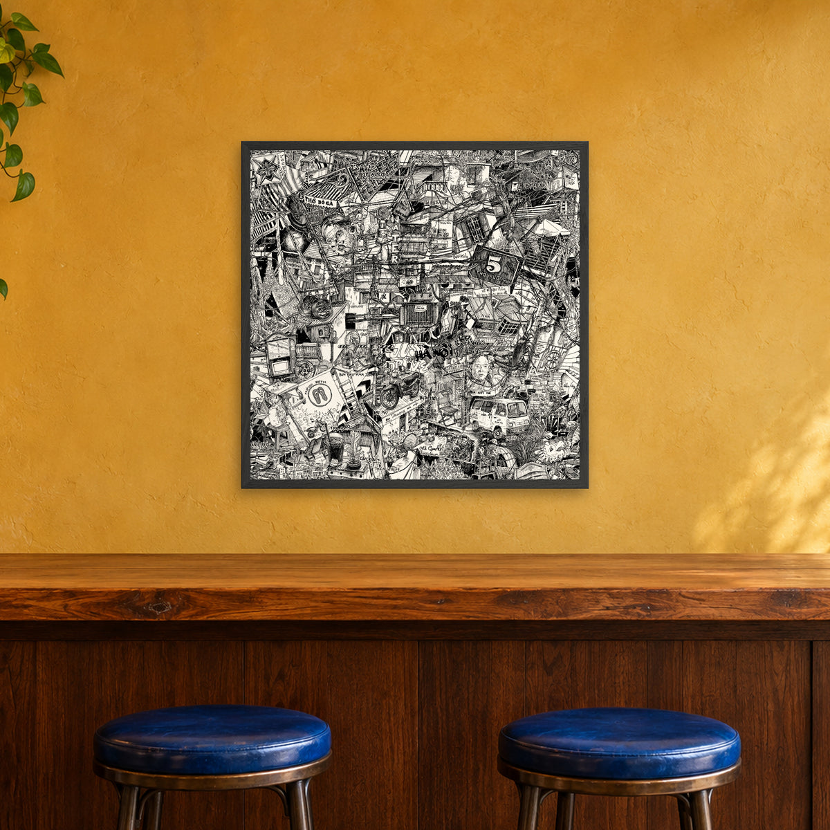 Hanoi fine art poster 70 × 70 cm in a black wood frame above the counter of a café bar