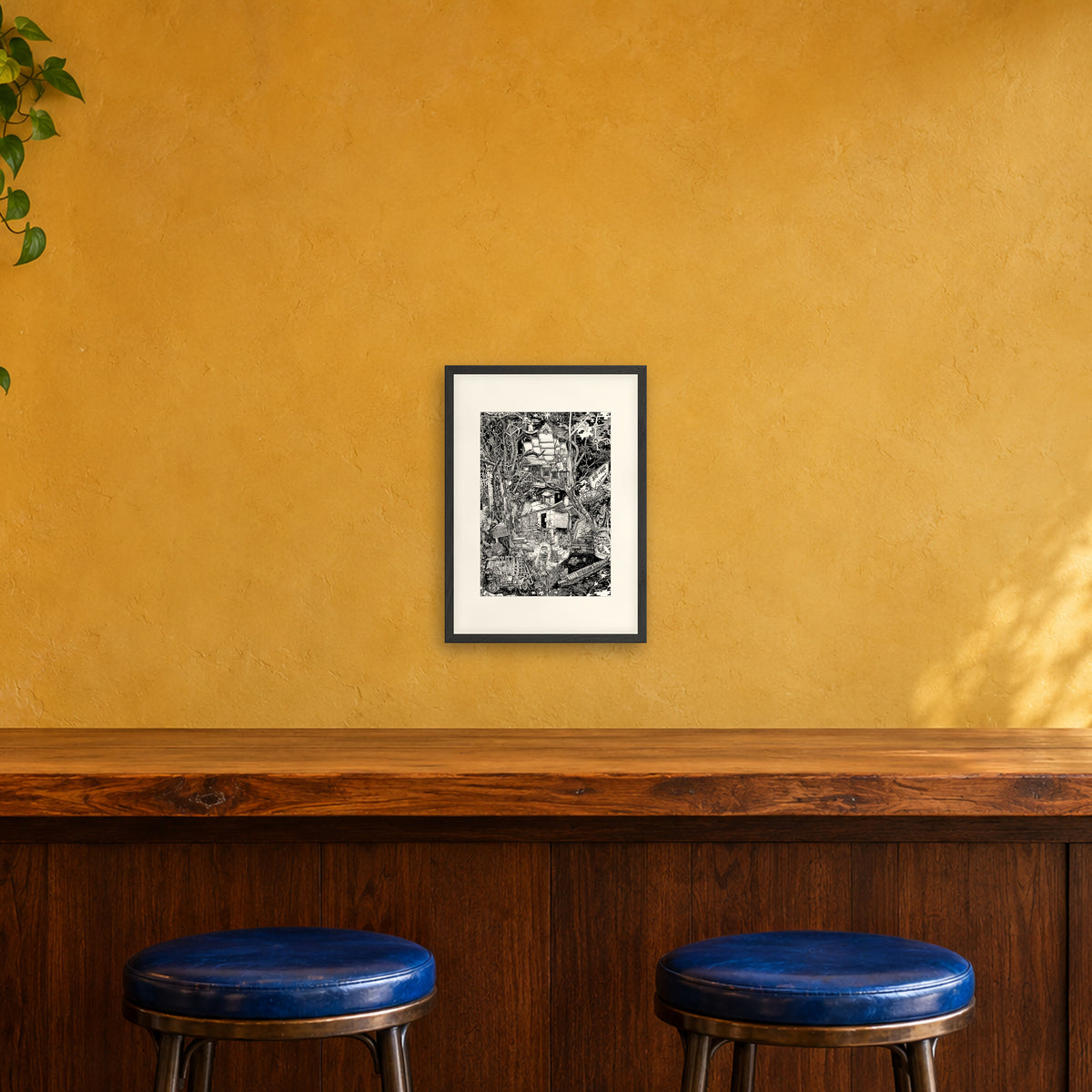 Laos fine art poster A3 portrait in a black wood frame with white passepartout above a café bar counter