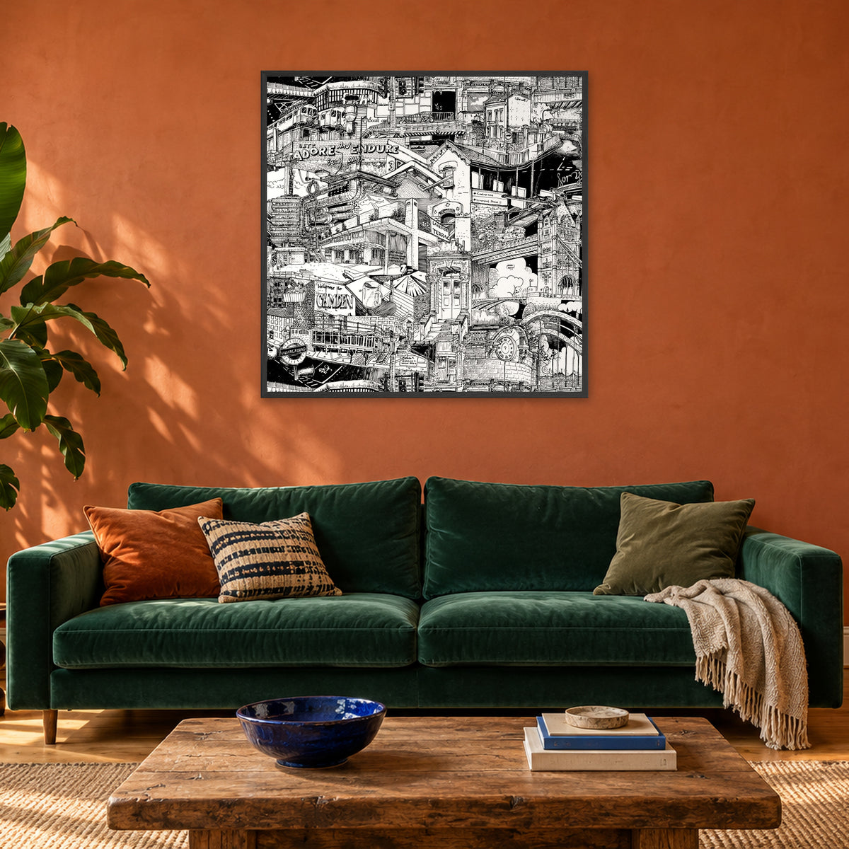 London fine art poster 100 × 100 cm in a black wood frame above a green velvet sofa in a terracotta living room