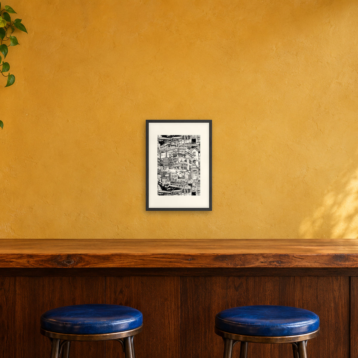 London fine art poster A3 portrait in a black wood frame with white passepartout above a café bar counter