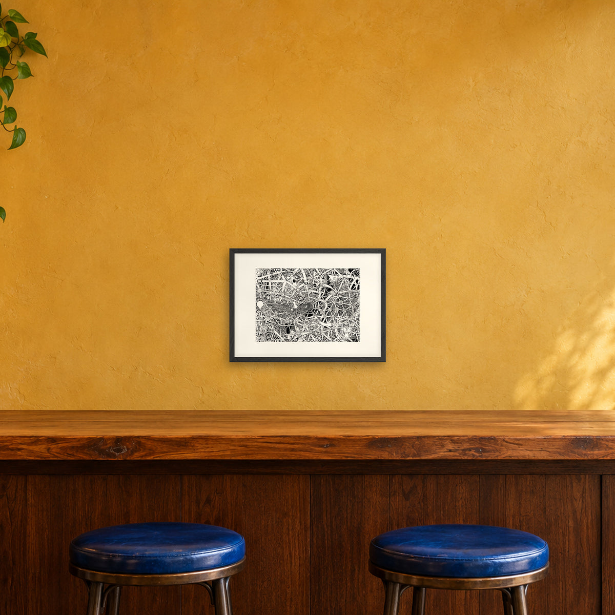 Universe fine art poster A3 landscape in a black wood frame with white passepartout above a café bar counter