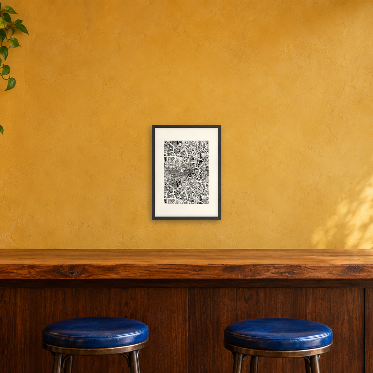 Universe fine art poster A3 portrait in a black wood frame with white passepartout above a café bar counter