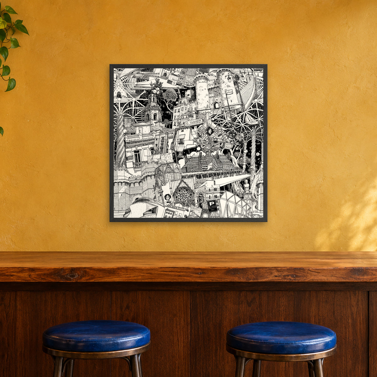Valencia fine art poster 70 × 70 cm in a black wood frame above the counter of a café bar